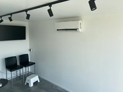 Binnenunit in een lichte ruimte met spots aan het plafond